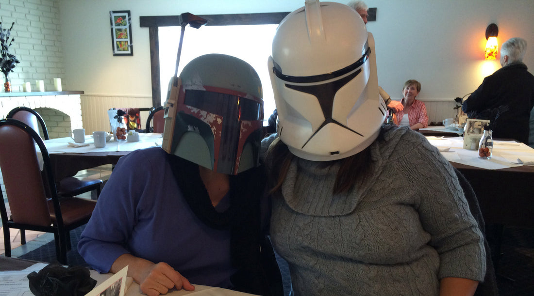 women with star wars helmets at a restaurant